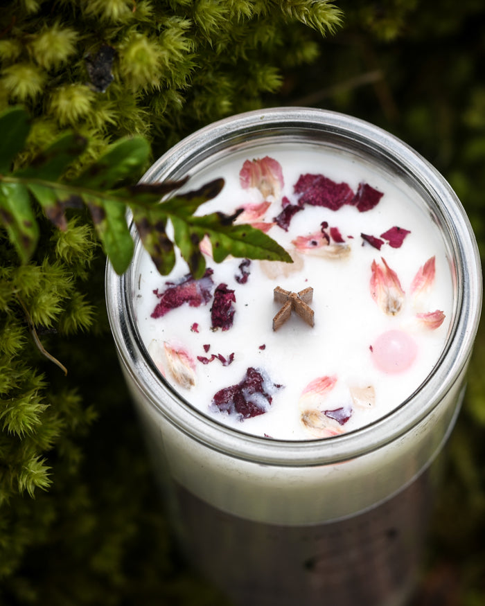 Top view of a Love Ritual Candle with rose quartz and flower petals by O Apothecary