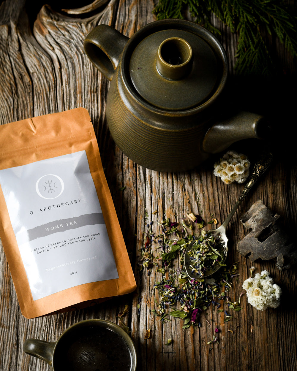 Loose leaf womb tea scene with kettle and tea cup